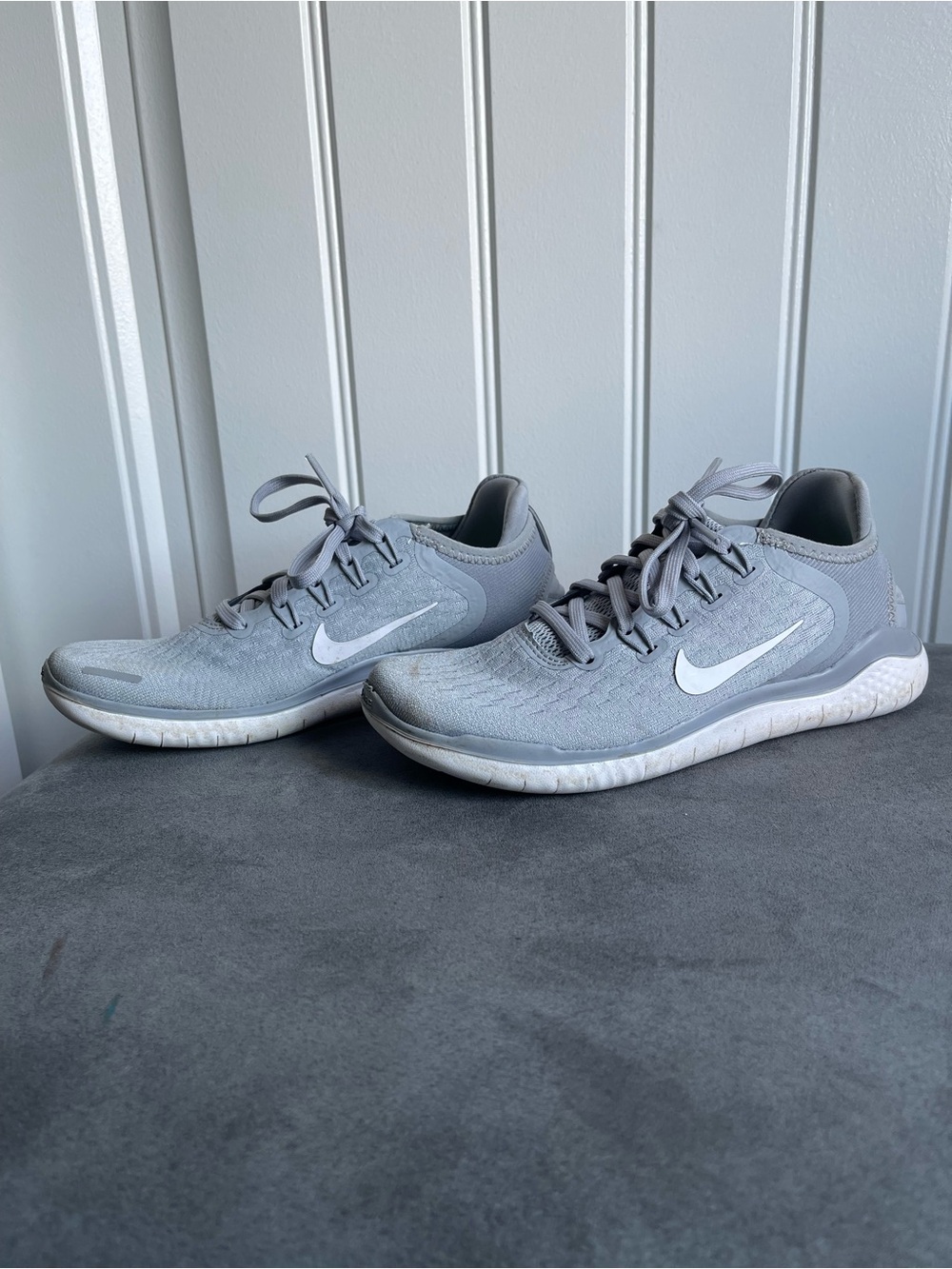 Nike Gray Knit Running Sneakers with White Swoosh.